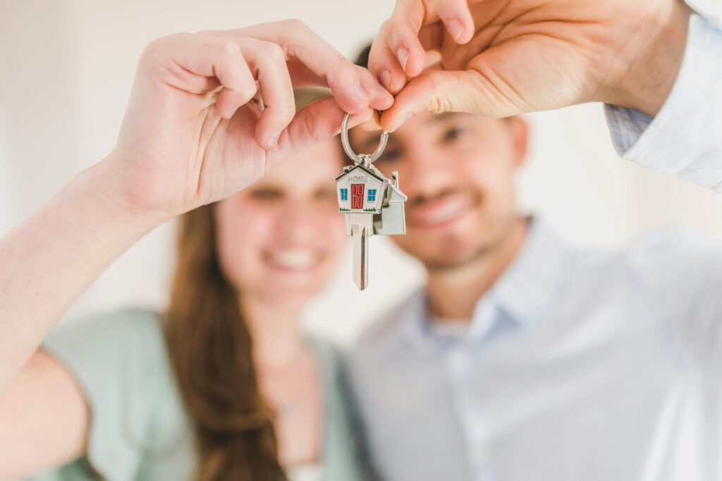 pexels-photo-8293700-8293700 Happy Couple Holding and Showing a House Key